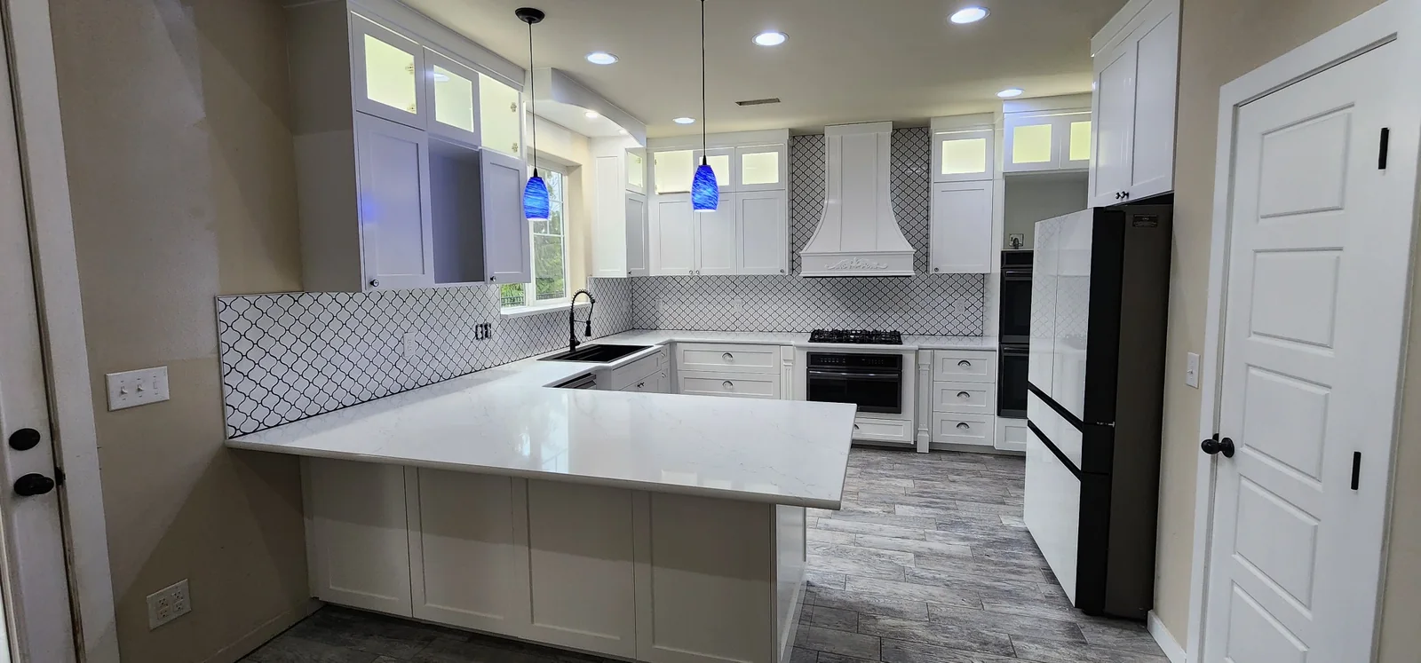 Refinished white kitchen cabinets and detailed interior painting