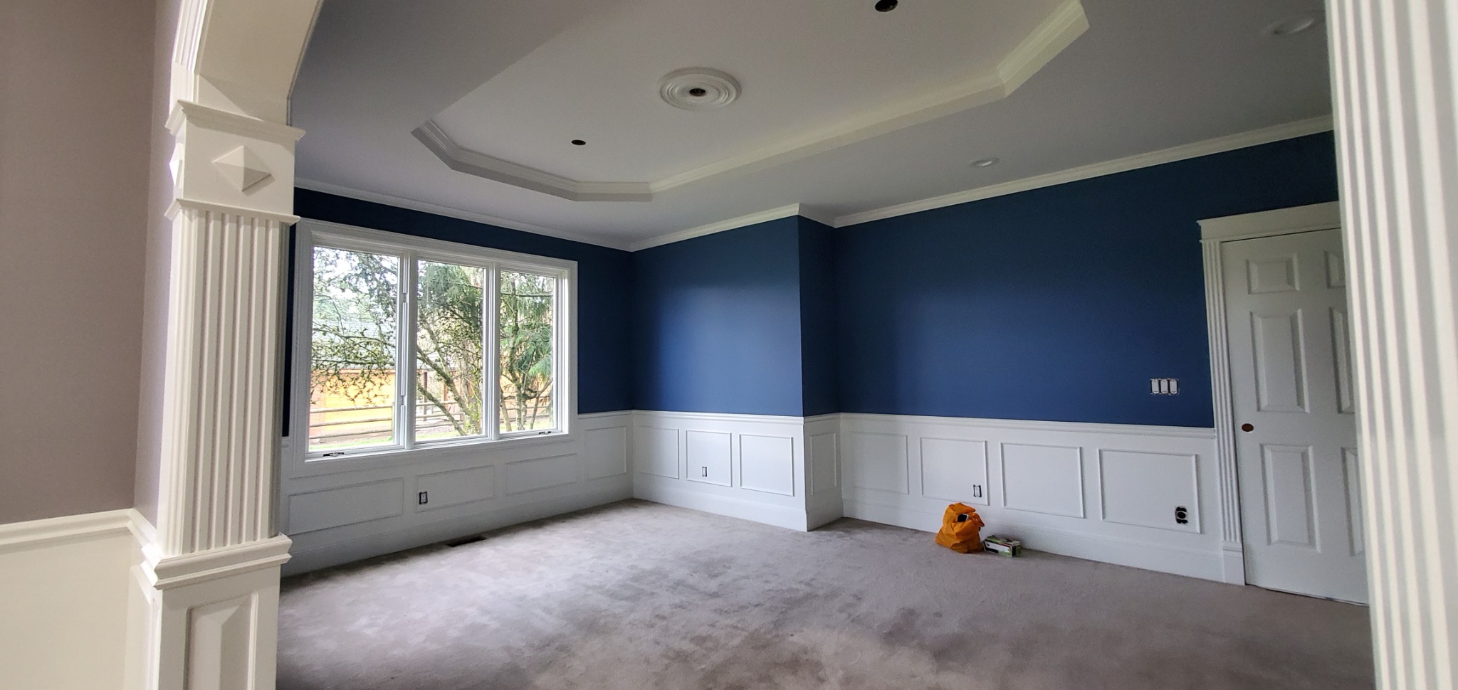 After: navy blue walls and white architectural trim