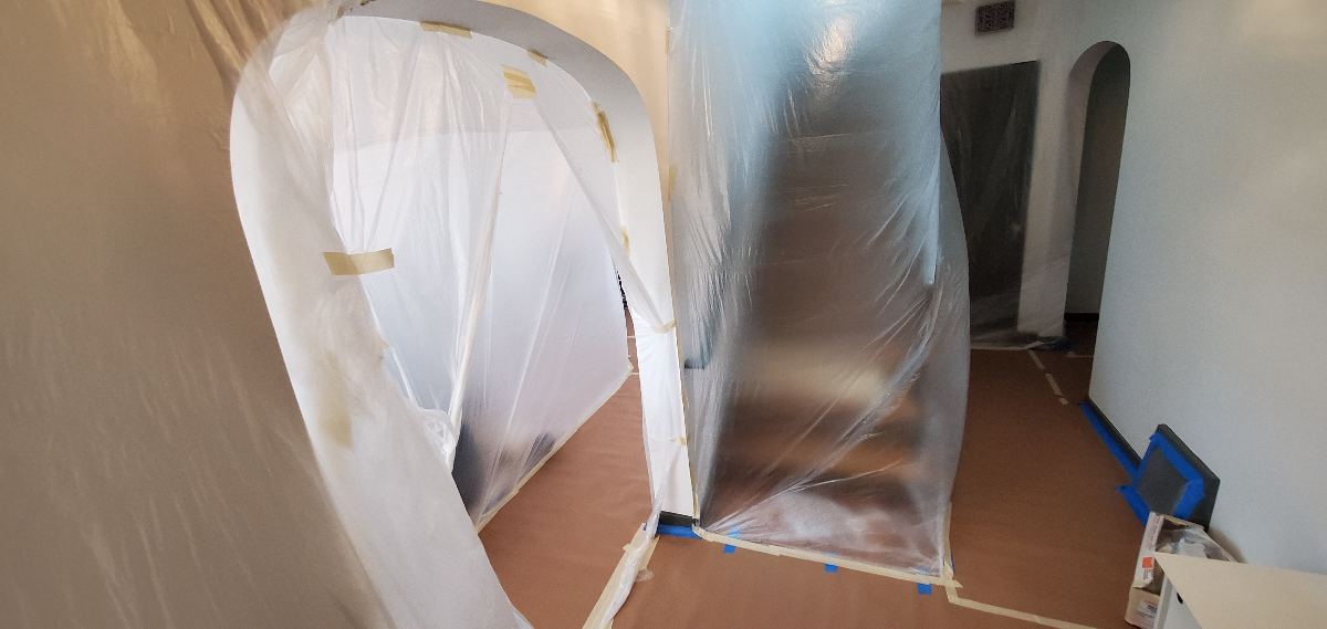 Plastic and paper masking protecting adjacent surfaces
