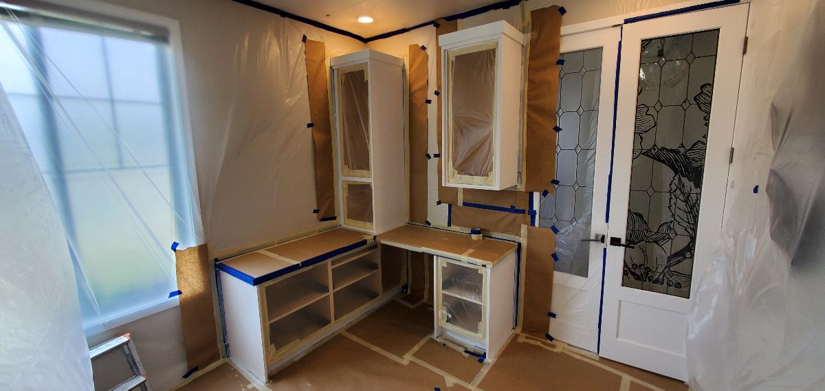 Built-in office cabinetry masked and prepared for finishing